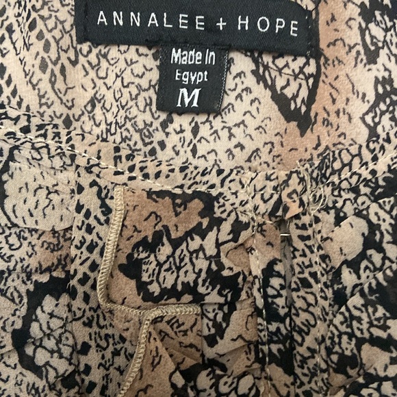 Puffy sleeves,ruffles 1/2 way down front opening. 100% polyester. - Picture 4 of 7